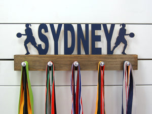 Our personalized basketball medal holder is a unique gift for the b-baller in your life. This display will be the perfect way for her to show off all of her awards. This design comes in a variety of colors, or you can pick from our other choices of sports or phrases so we can customize it just the way you want!