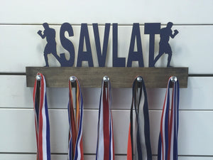 Our personalized boxing medal holder is a unique gift for the boxer in your life. This display will be the perfect way for them to show off all of their awards. This design comes in a variety of colors, or you can pick from our other choices of sports or phrases so we can customize it just the way you want!