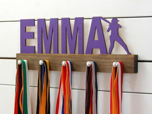 Our personalized softball medal holder is a unique gift for the softball player in your life. This display will be the perfect way for her to show off all of her awards. This design comes in a variety of colors, or you can pick from our other choices of sports or phrases so we can customize it just the way you want!