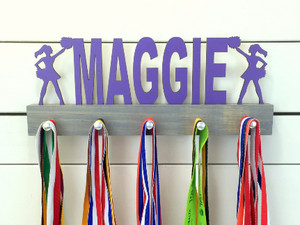 Our personalized cheerleader medal holder is a unique gift for the cheerleader in your life. This display will be the perfect way for her to show off all of her well-deserved awards. This design comes in a variety of colors, or you can pick from our other choices of sports or phrases so we can customize it just the way you want!