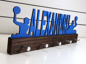 Our personalized water polo medal holder is a unique gift for any water polo player so they can display all of their awesome and well-deserved awards. This design comes in a variety of colors, or you can pick from our other choices of sports or phrases so we can customize it just the way you want!