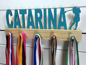 Our personalized golf medal holder is a unique gift for the golfer in your life. This display will be the perfect way for her to show off all of her well-deserved awards. This design comes in a variety of colors, or you can pick from our other choices of sports or phrases so we can customize it just the way you want!