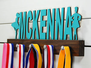 Our personalized Irish dance medal holder is a unique gift for the dancer in your life. This display will be the perfect way for them to show off all of their well-deserved awards. This design comes in a variety of colors, or you can pick from our other choices of sports or phrases so we can customize it just the way you want!