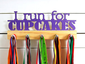 Our running medal holder is the perfect gift for any runner who has their priorities straight. This design comes in a variety of colors, or you can pick from our other choices of sports or phrases. Better yet, tell us your own personal mantra so we can customize a unique medal holder just for you!