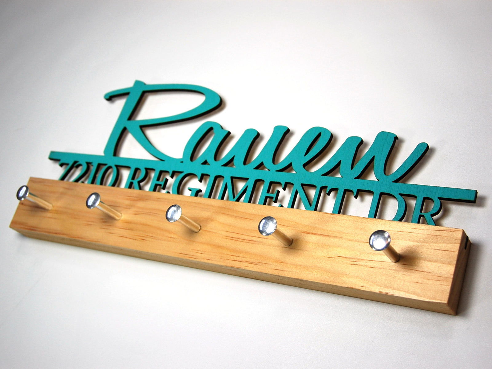 "Rauen" key hook display in turquoise text on a clear base