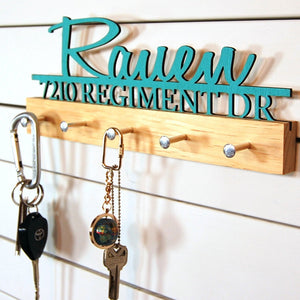 "Rauen" key hook display in turquoise text on a clear base