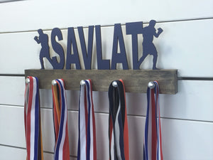 Our personalized boxing medal holder is a unique gift for the boxer in your life. This display will be the perfect way for them to show off all of their awards. This design comes in a variety of colors, or you can pick from our other choices of sports or phrases so we can customize it just the way you want!