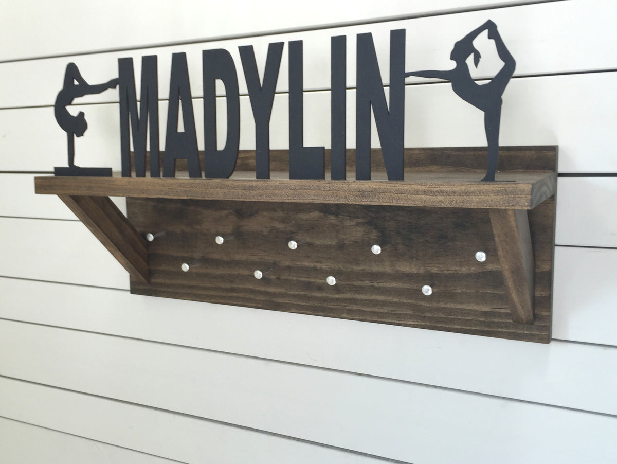 Our personalized trophy shelf and medal holder is a great gift for any winner so they can display all of their awesome awards. This design comes in a variety of colors, or you can pick from our other choices of sports or phrases so we can customize a unique trophy shelf just for you!