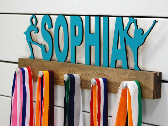  Our personalized figure skater medal holder is a unique gift for the skater in your life. This display will be the perfect way for them to show off all of their well-deserved awards. This design comes in a variety of colors, or you can pick from our other choices of sports or phrases so we can customize it just the way you want!