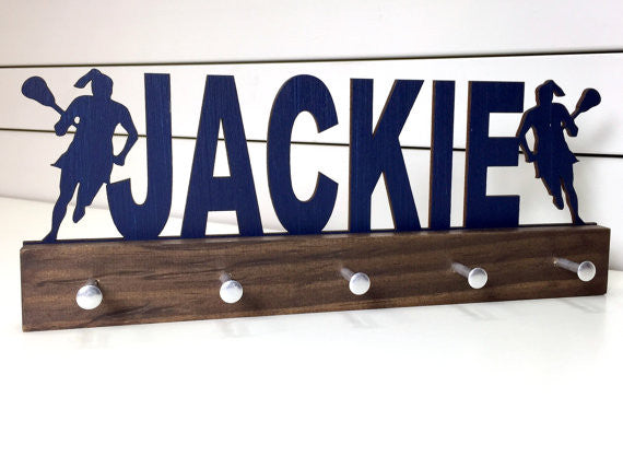  Our personalized lacrosse medal holder is a unique gift for the lacrosse player in your life. This display will be the perfect way for her to show off all of her well-deserved awards. This design comes in a variety of colors, or you can pick from our other choices of sports or phrases so we can customize it just the way you want!