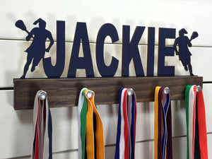  Our personalized lacrosse medal holder is a unique gift for the lacrosse player in your life. This display will be the perfect way for her to show off all of her well-deserved awards. This design comes in a variety of colors, or you can pick from our other choices of sports or phrases so we can customize it just the way you want!