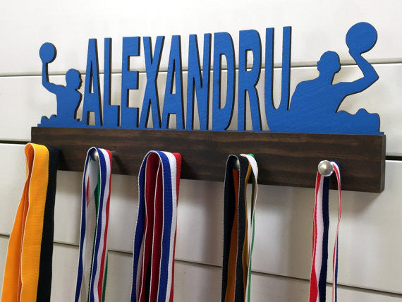  Our personalized water polo medal holder is a unique gift for any water polo player so they can display all of their awesome and well-deserved awards. This design comes in a variety of colors, or you can pick from our other choices of sports or phrases so we can customize it just the way you want!