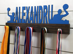  Our personalized water polo medal holder is a unique gift for any water polo player so they can display all of their awesome and well-deserved awards. This design comes in a variety of colors, or you can pick from our other choices of sports or phrases so we can customize it just the way you want!