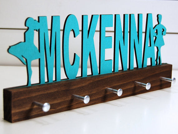  Our personalized Irish dance medal holder is a unique gift for the dancer in your life. This display will be the perfect way for them to show off all of their well-deserved awards. This design comes in a variety of colors, or you can pick from our other choices of sports or phrases so we can customize it just the way you want!