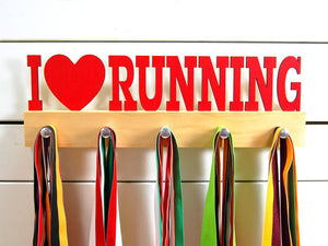 Our running medal holder is the perfect gift for anyone who loves running as much as we do! This display will help them show off all of their well-deserved awards. This design comes in a variety of colors, or you can pick from our other choices of sports or phrases. Better yet, tell us your own personal mantra so we can customize a unique medal holder just for you!