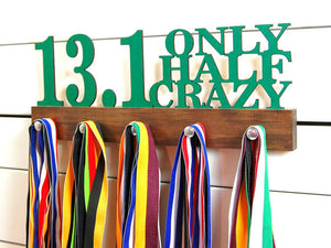 Our half marathon running medal holder is a great gift for any runner so they can display all of their awesome awards. This design comes in a variety of colors, or you can pick from our other choices of sports or phrases. Better yet, tell us your own personal mantra so we can customize a unique medal holder just for you!
